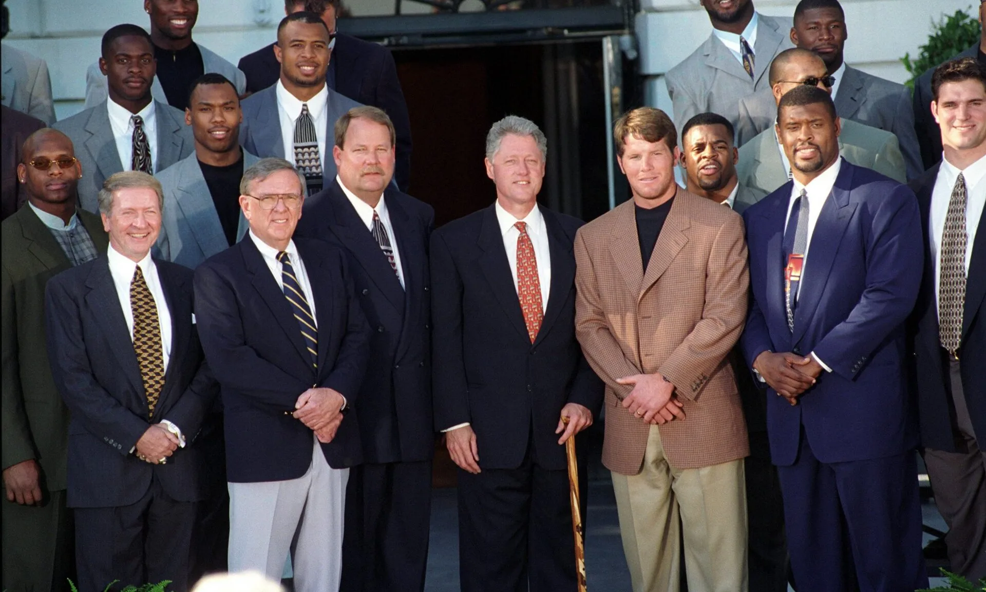Mike Holmgren beside President Bill Clinton, with Brett Favre, Reggie White and Packers players at the White House