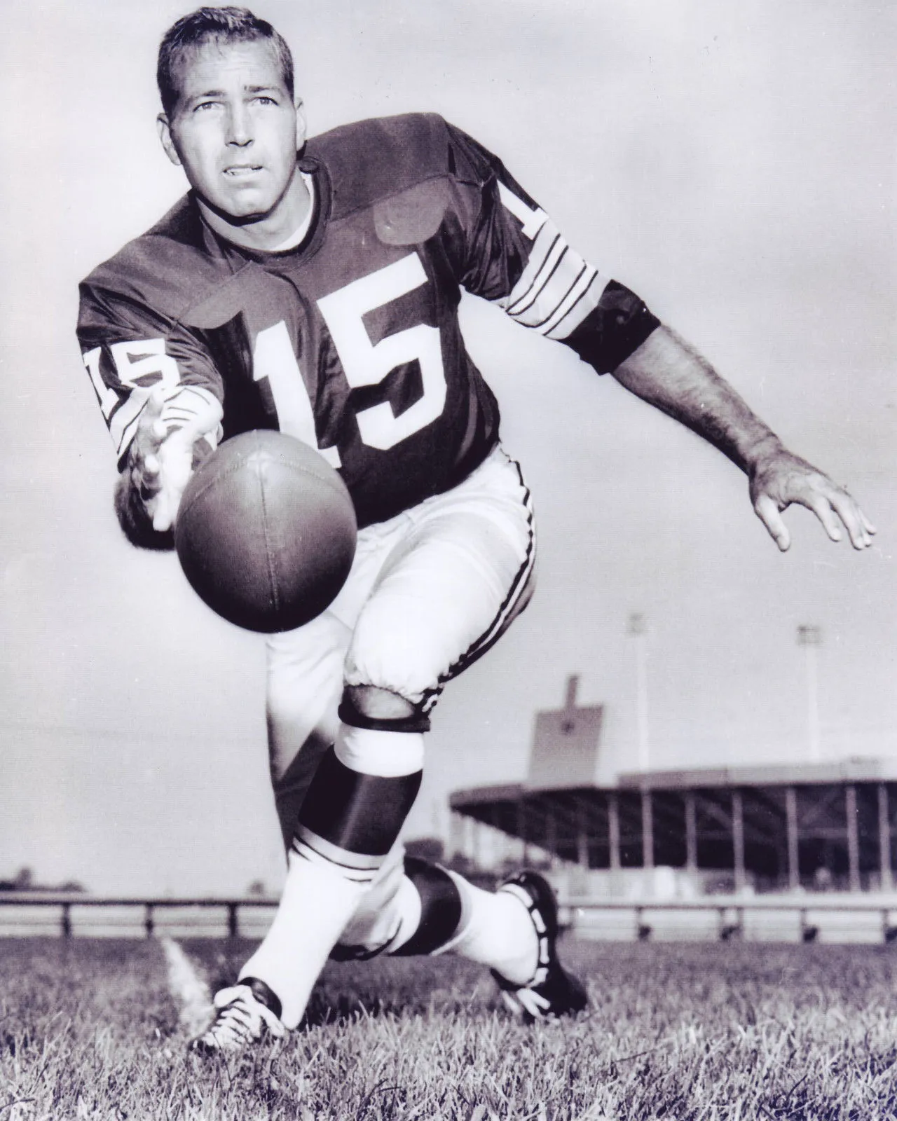 Bart Starr in his number 15 Packers uniform, holding a football